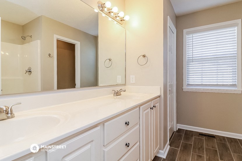 a bathroom with a large mirror and a large sink