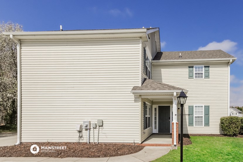 a white house with a street light in front of it