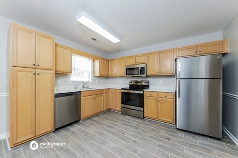 a kitchen with stainless steel appliances and wooden cabinets