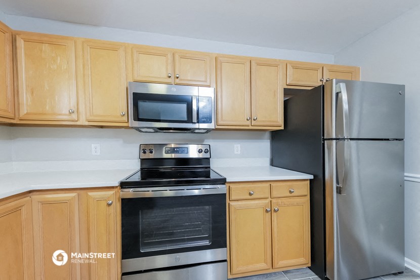 a kitchen with stainless steel appliances and wooden cabinets