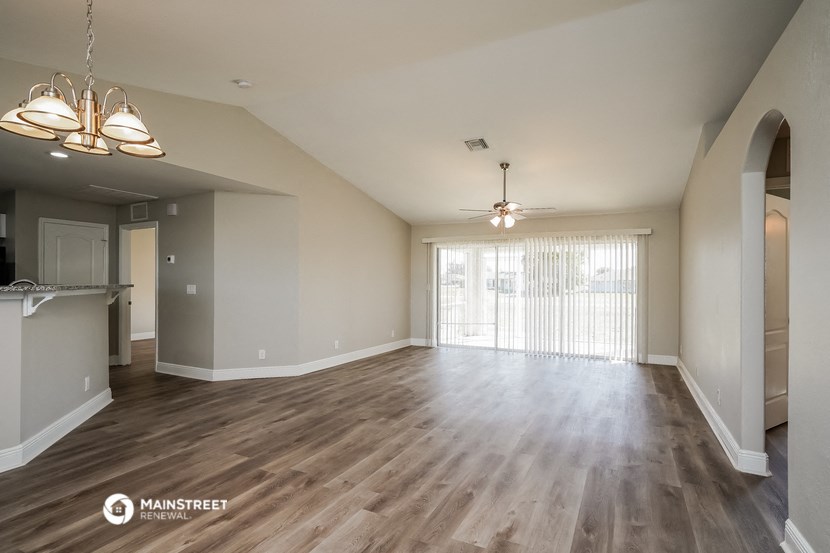 the living room and dining room of an open floor plan
