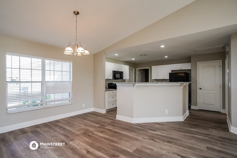 the kitchen is open to the living room and dining room