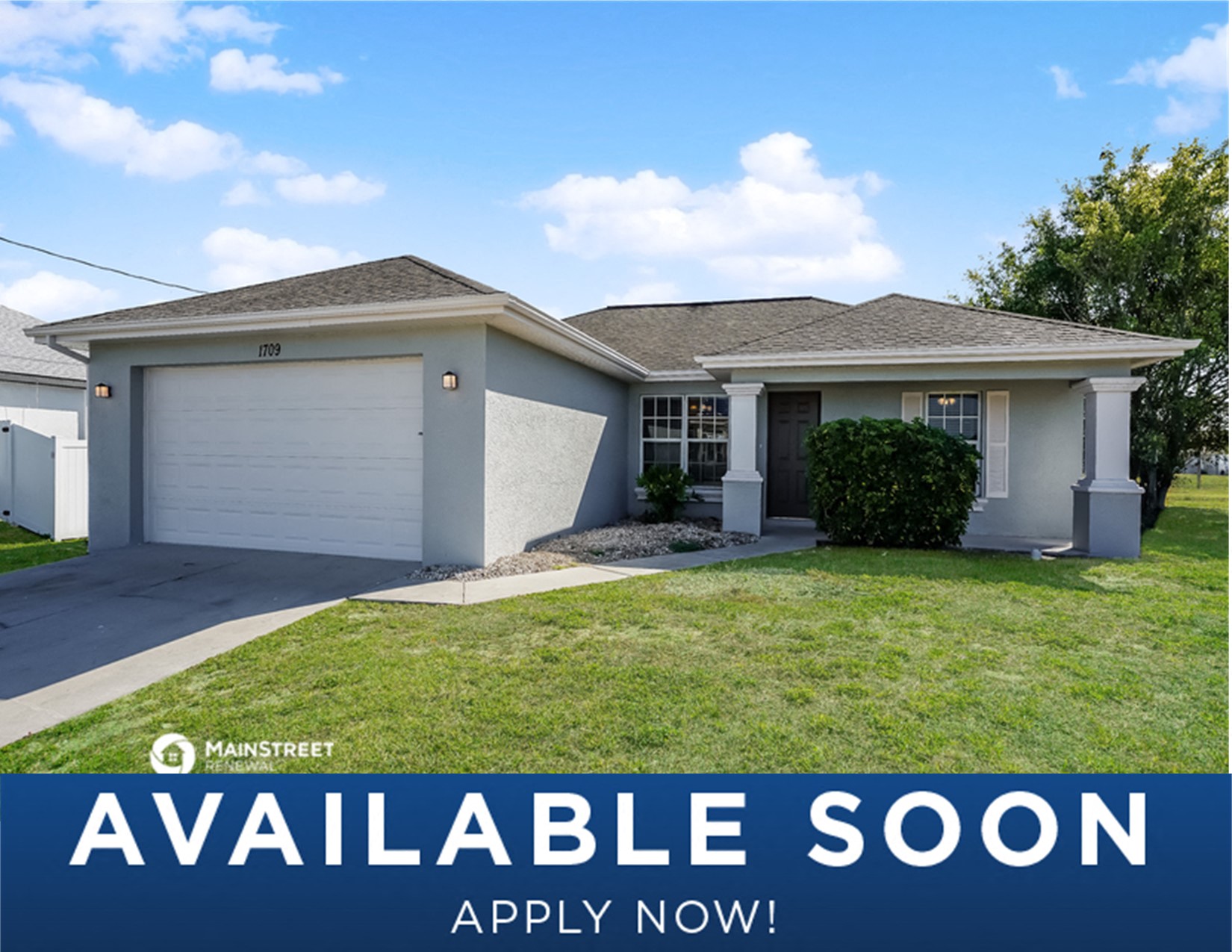 a house with a lawn and a garage door