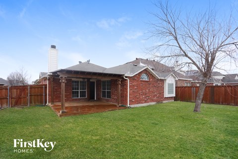 A house with a brick exterior and a white chimney is for sale.