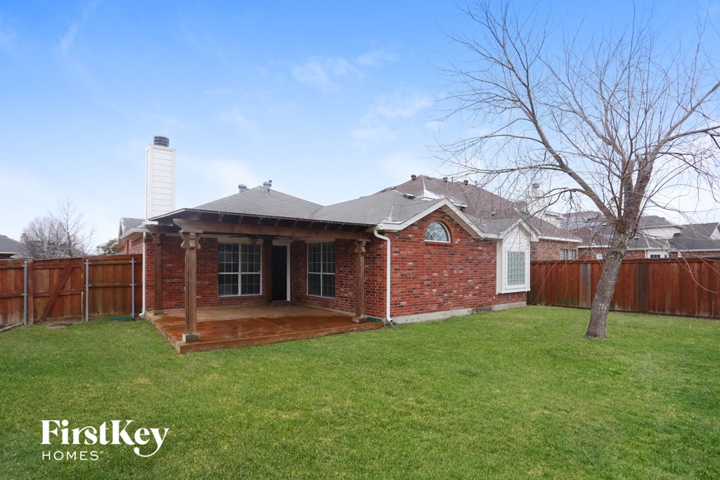 A house with a brick exterior and a white chimney is for sale.