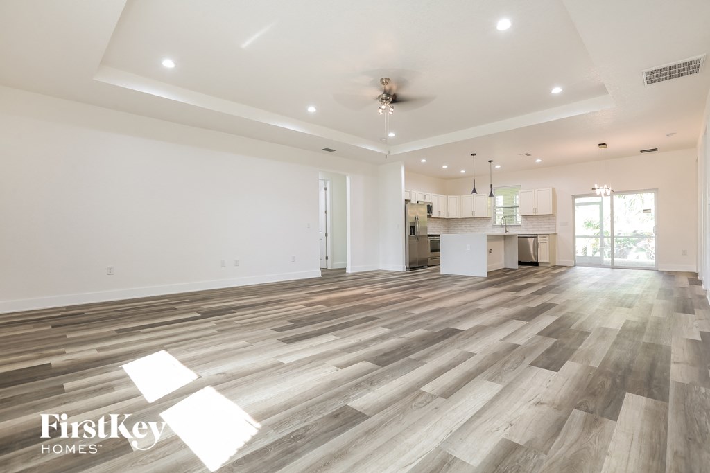the living room is open to the kitchen and dining room