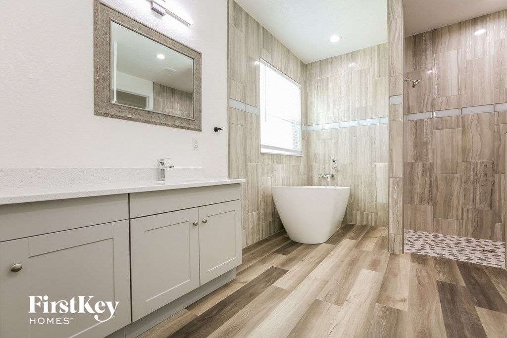 a bathroom with a sink and a toilet and a shower