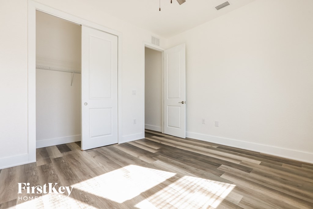 a living room with wood floors and white doors
