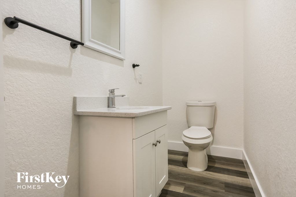 a bathroom with a toilet and a sink and a mirror