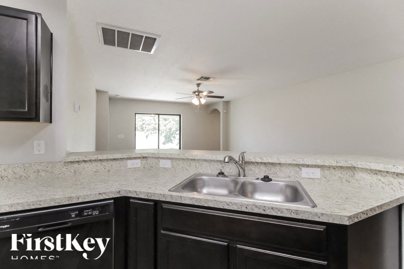 A kitchen with a sink and a FirstKey logo.