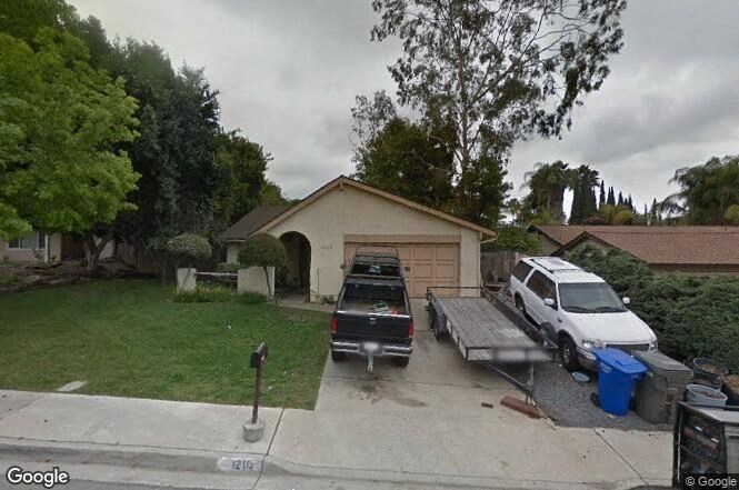 a truck is parked in front of a garage