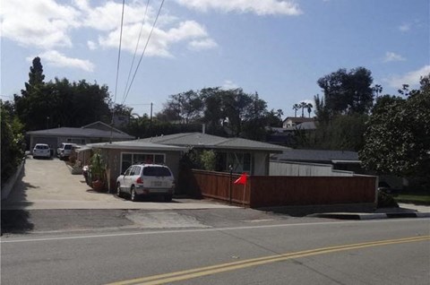 a house with a white car parked in front of it