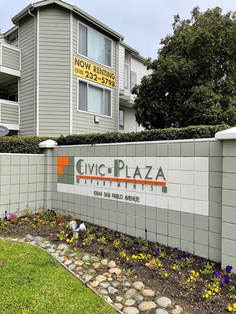 a sign for civic plaza in front of a building