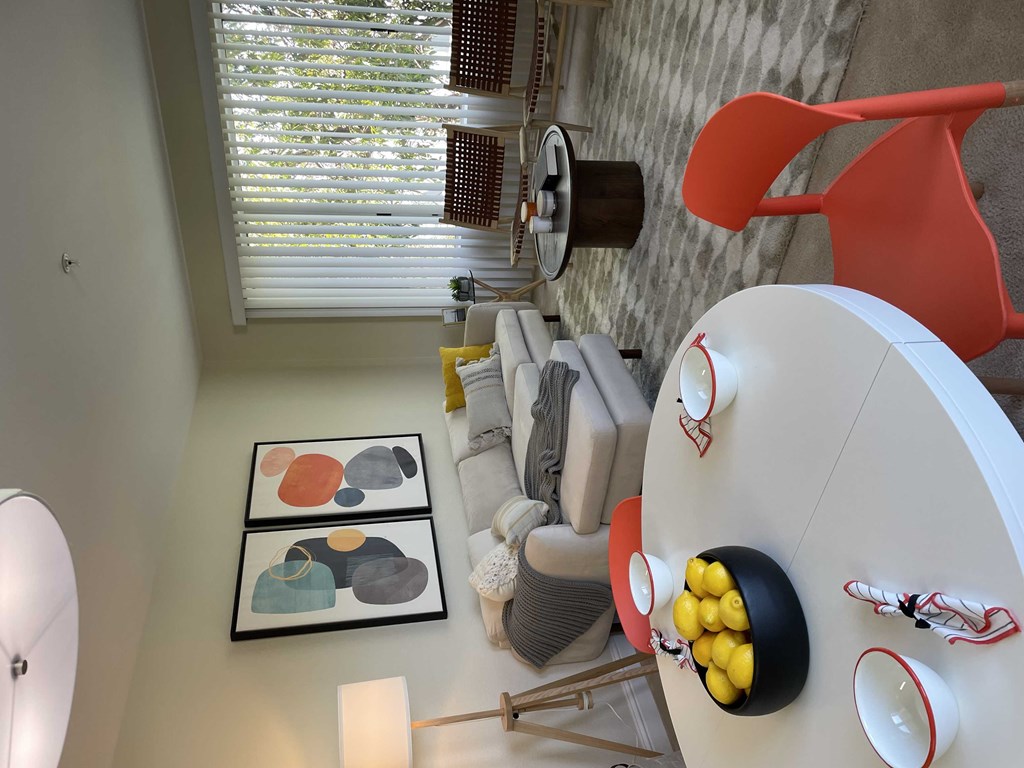 a rendering of a living room with a round table and a lamp