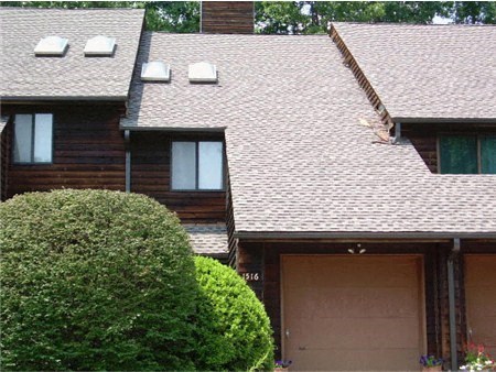 a house with a brown roof and a garage