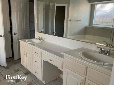 a bathroom with two sinks and a mirror