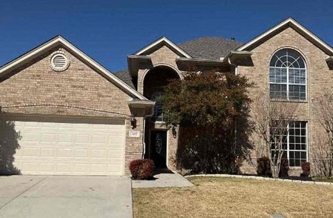 a brick house with a white garage door