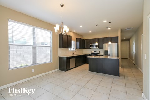 a kitchen with a large window and an island with a sink