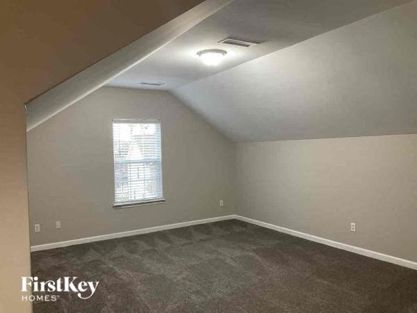 an empty room with carpet and a window