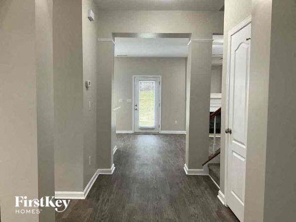 a hallway of a house with a door in the middle