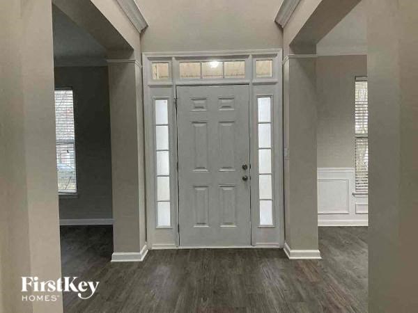 an empty living room with a white door
