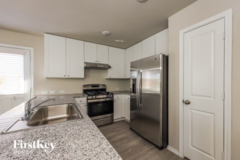 a kitchen with stainless steel appliances and granite counter tops