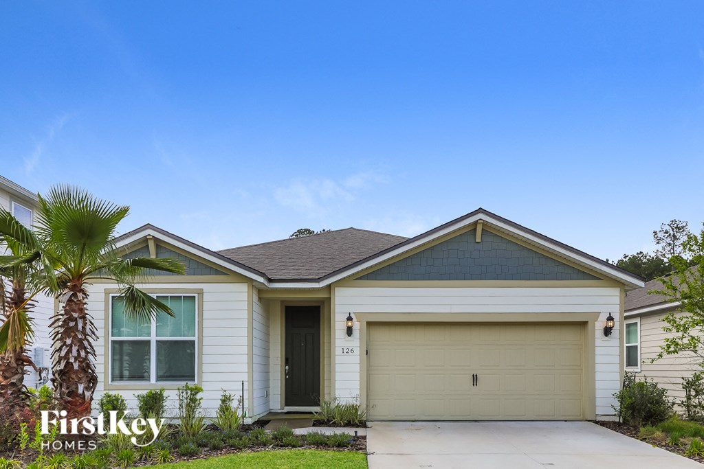 a white house with a palm tree in front of it