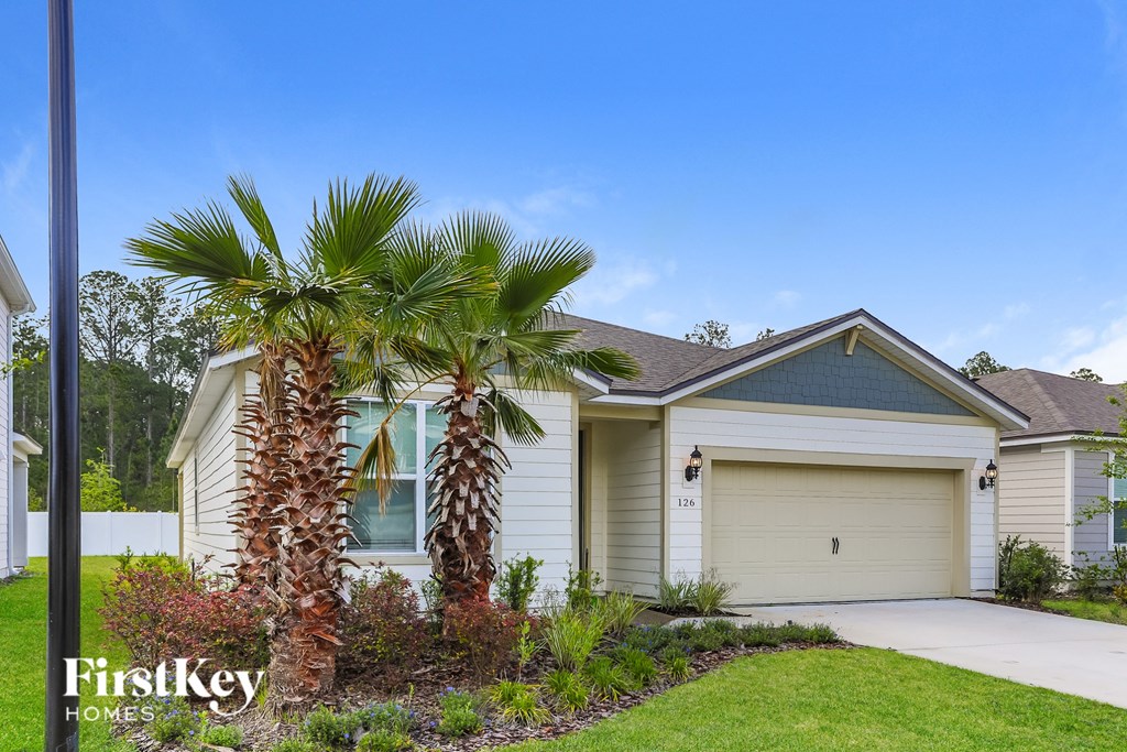 a house with palm trees in front of it