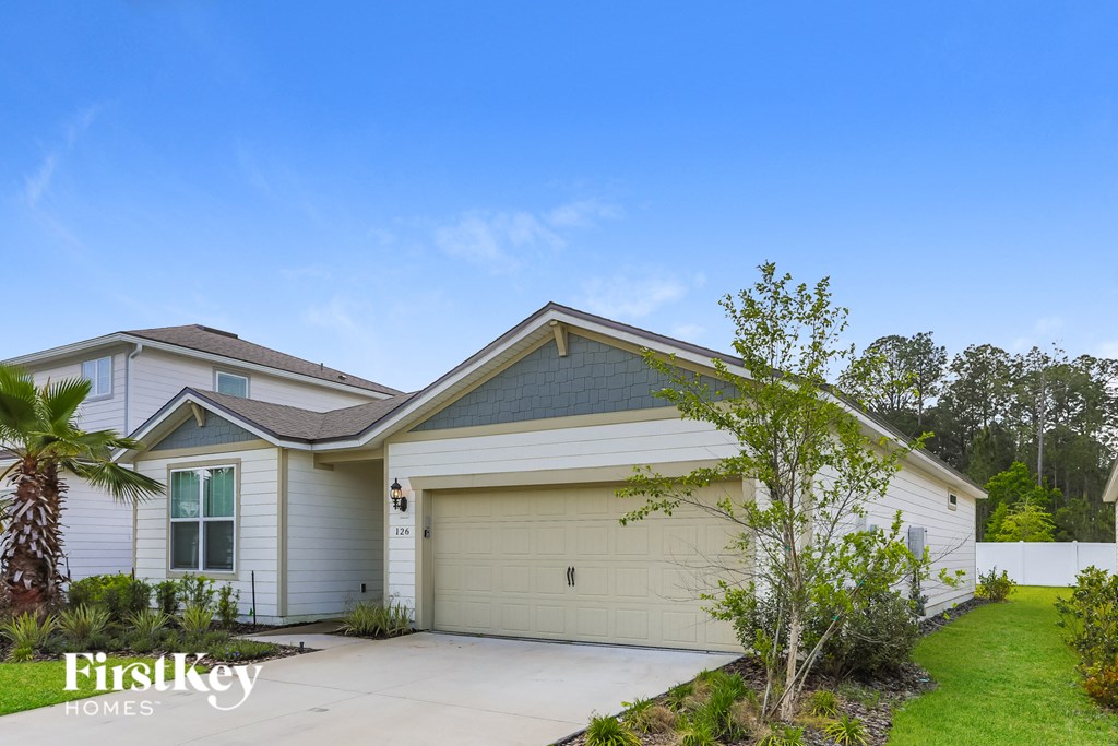 a beige and white house with a garage door