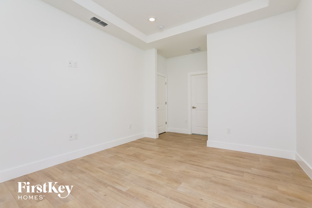 a living room with white walls and a wooden floor