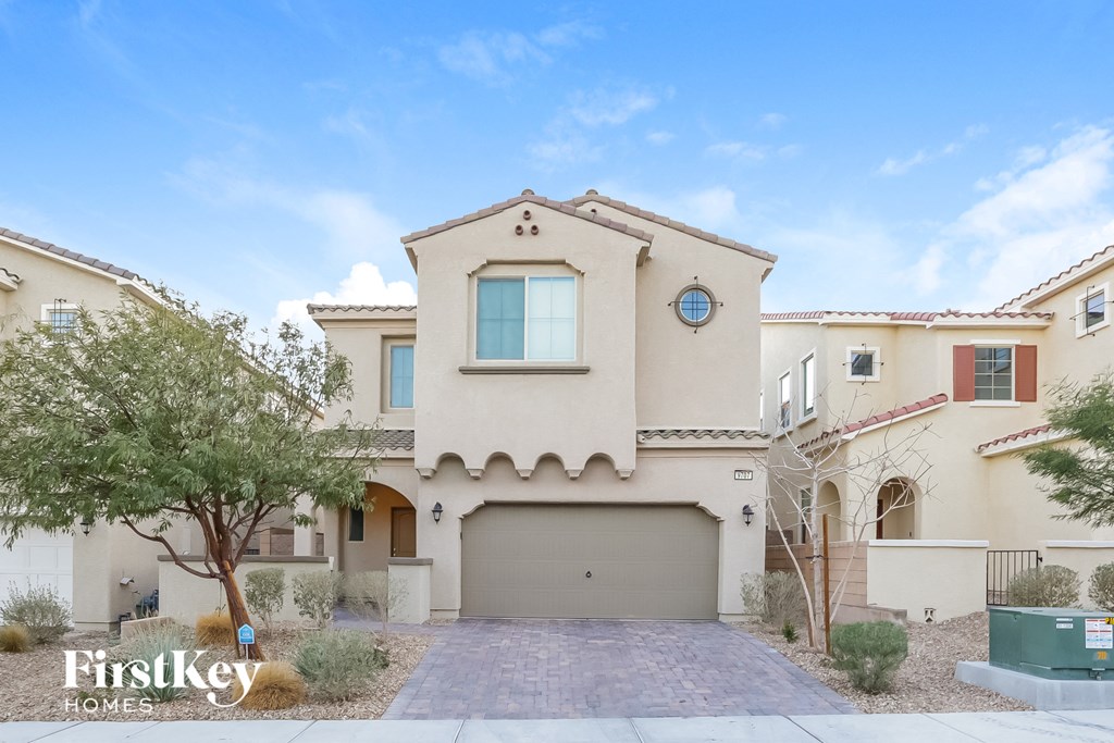 a beige house with a garage door in front of it