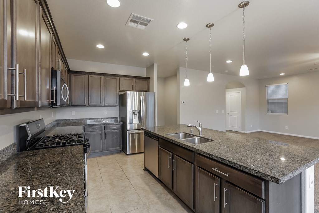 a kitchen with granite counter tops and stainless steel appliances