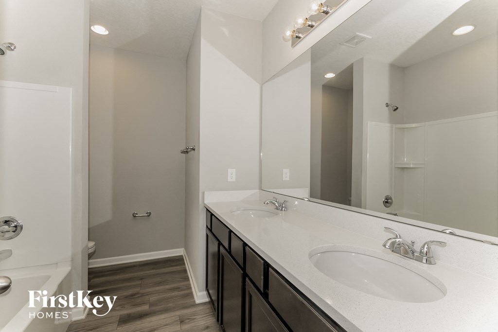 a bathroom with two sinks and a large mirror