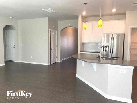 A kitchen with a stainless steel refrigerator and a white countertop.