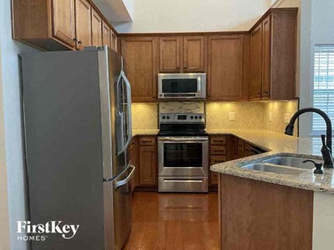 a kitchen with wooden cabinets and stainless steel appliances
