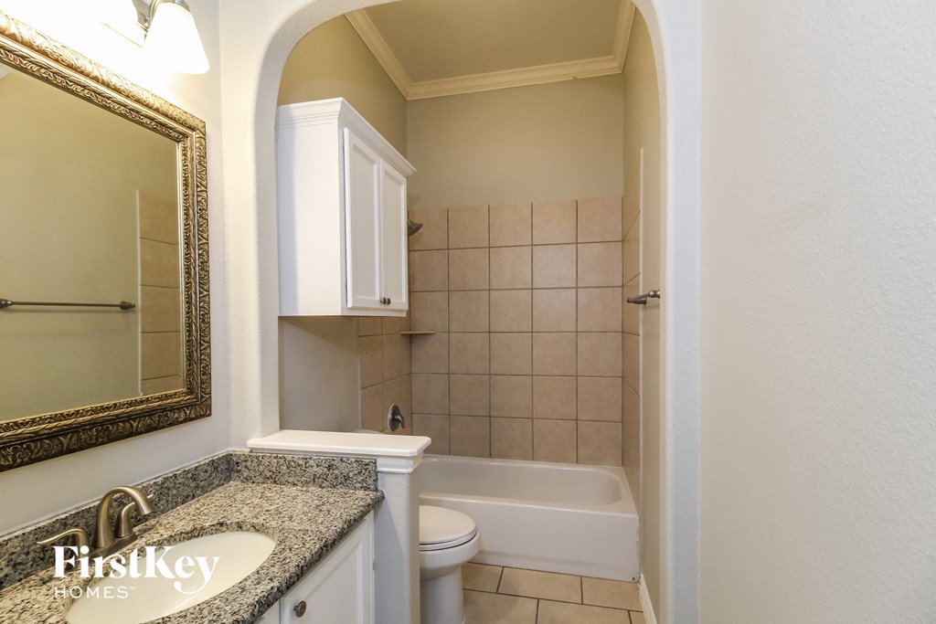 a bathroom with a sink toilet and a tub