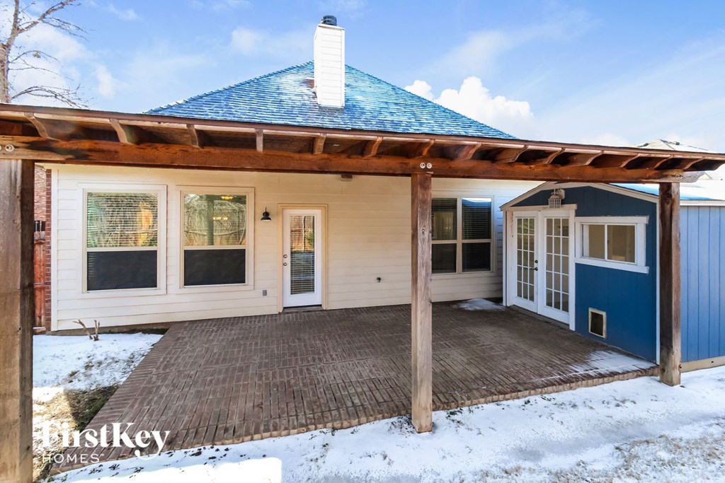the front of a house with a deck and a blue roof