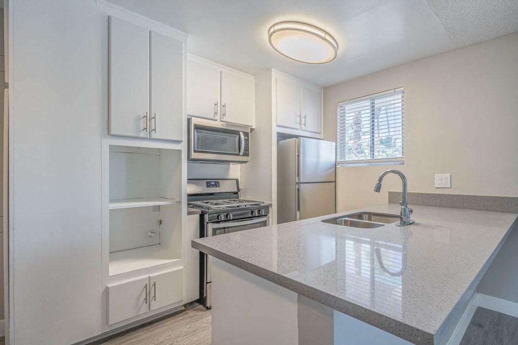 a kitchen with a counter top and a sink