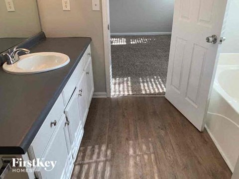 a bathroom with a sink and a white door