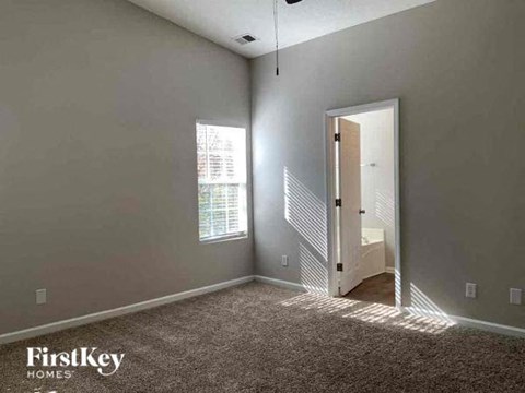 an empty room with a door to a bathroom