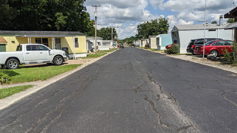 a street with rows of mobile homes on both sides of it