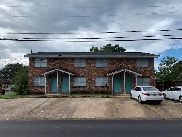 A house with a car parked in front.