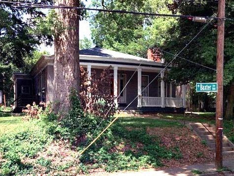 A house with a porch and a sign that says "Bartlett".