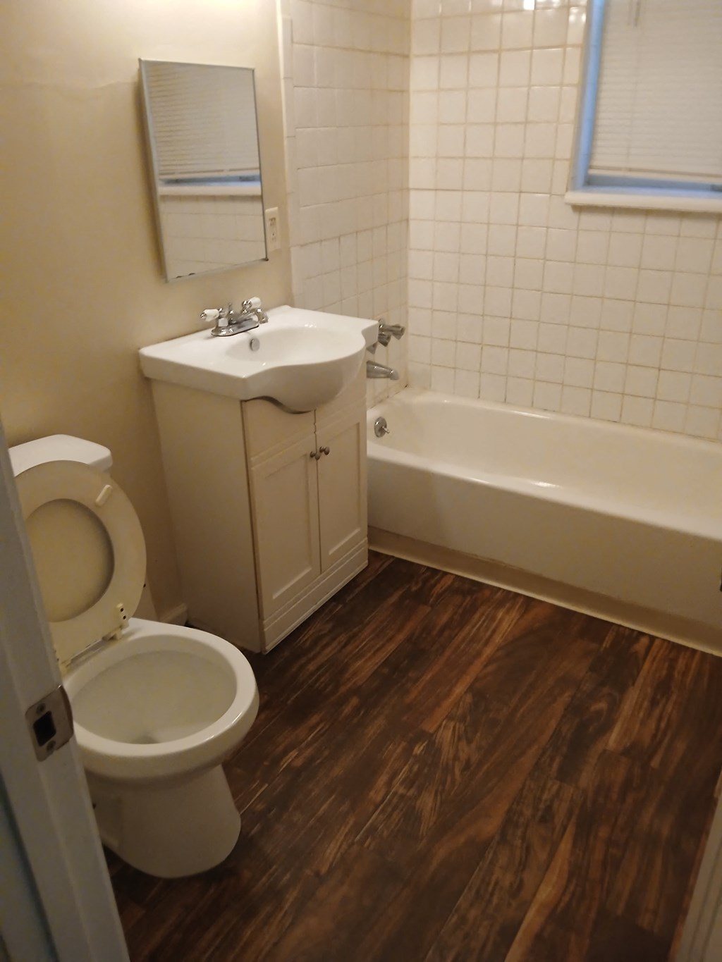 a bathroom with a toilet and a sink and a bath tub