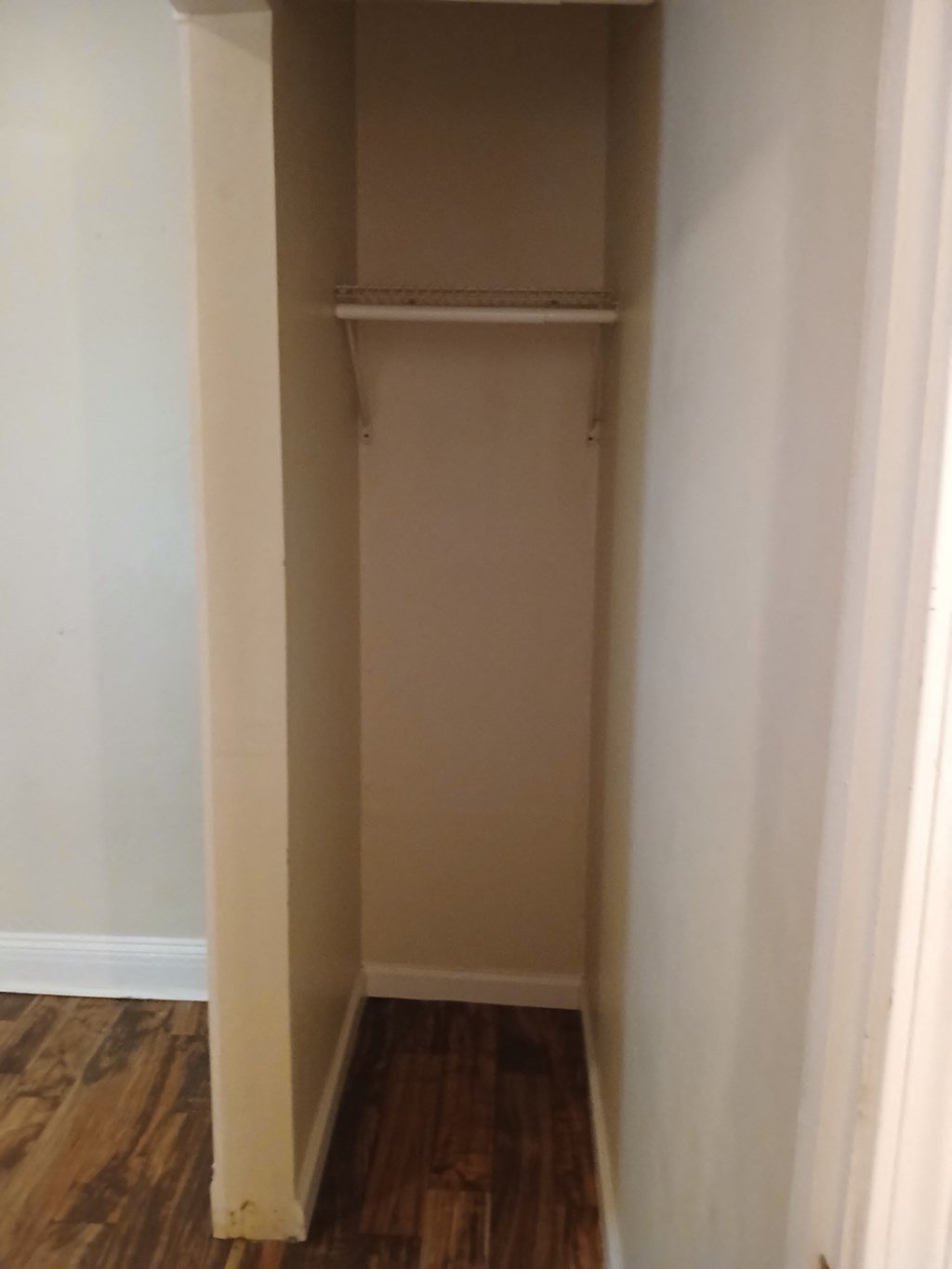 the closet in the corner of the room is empty