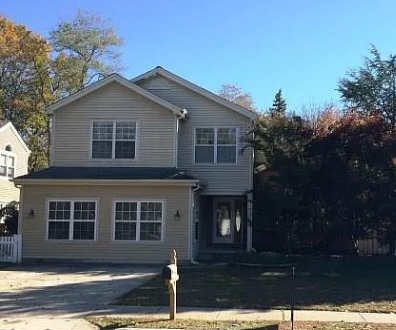 a house with a fire hydrant in front of it