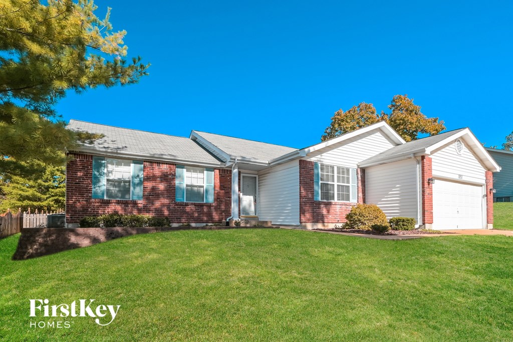 A house with a red brick exterior and a white garage door.