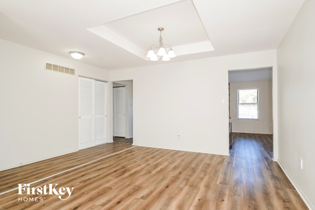 A room with wooden floors and a white ceiling with a light fixture.