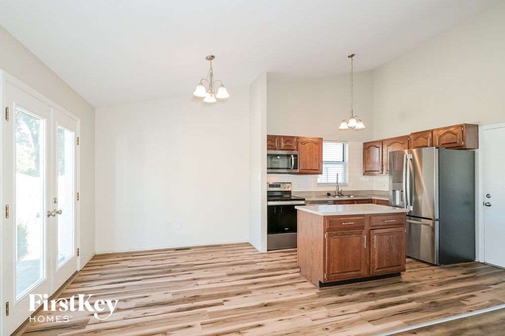 A kitchen with wooden floors and a center island.