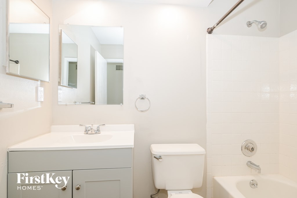 A white bathroom with a FirstKey Homes logo.